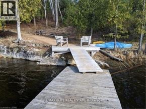 Frontenac (Frontenac Centre) apartment for rent - A wooden dock leads to a body of water with a sign that says REALTOR.