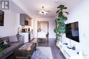 Toronto (South Parkdale) condo for rent - A living room with a grey couch and a wooden coffee table.