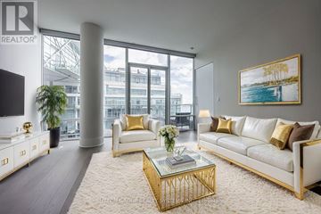 Toronto (Waterfront Communities) condo for rent - A living room with a white couch, a gold coffee table, and a painting on the wall.