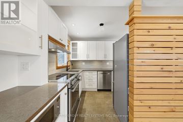 Toronto (Wexford-Maryvale) apartment for rent - A modern kitchen with white cabinets and stainless steel appliances.