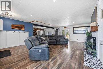 St Clair apartment for rent - A living room with a grey sofa and a wooden floor.