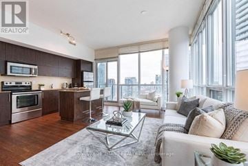 Toronto (Waterfront Communities) condo for rent - A modern kitchen with dark wood cabinets and stainless steel appliances.