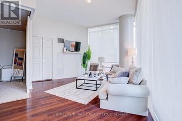 Toronto (Waterfront Communities) condo for rent - A living room with a white couch and a coffee table.