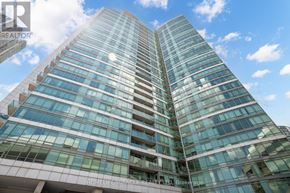 Toronto (Waterfront Communities) condo for rent - A tall building with many windows is being advertised by a realtor.