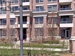 Markham (Unionville) condo for rent - A tall building with a balcony on the second floor.