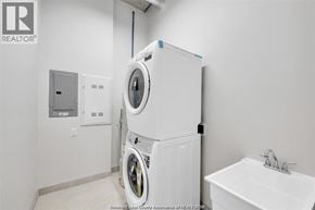 Tecumseh apartment for rent - A white washing machine is in a small laundry room.