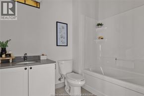 Tecumseh apartment for rent - A white bathroom with a toilet, sink, and bathtub.
