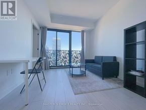 Toronto (Church-Yonge Corridor) condo for rent - A living room with a view of the city through the windows.