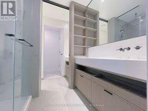 Toronto (Church-Yonge Corridor) condo for rent - A bathroom with a glass shower stall and a vanity with a mirror.