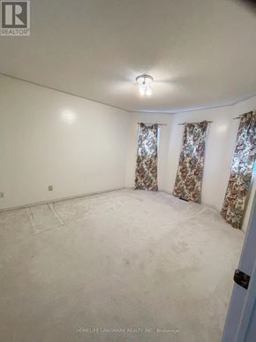 Barrie (Holly) apartment for rent - A room with a light on and curtains on the window.