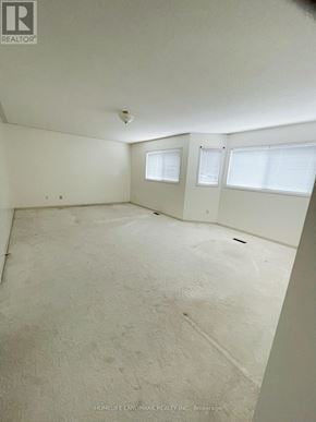 Barrie (Holly) apartment for rent - A large empty room with a window and a door.