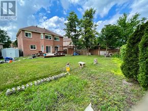 Barrie (Holly) apartment for rent - A backyard with a lawn, a fire hydrant, and a fence.