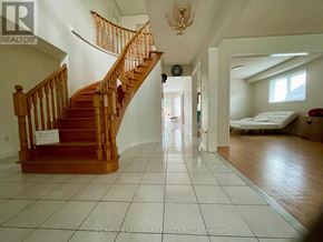 Barrie (Holly) apartment for rent - A large open room with a staircase and a bed in the background.