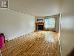 Barrie (Holly) apartment for rent - A room with wooden flooring and a fireplace in the corner.
