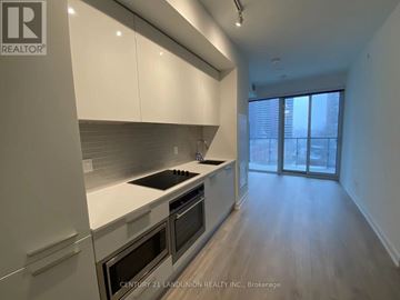 Toronto (Church-Yonge Corridor) condo for rent - A modern kitchen with white cabinets and stainless steel appliances.