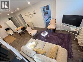 St. Catharines apartment for rent - A living room with a couch, chair, and television.