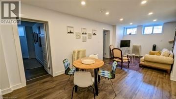 St. Catharines apartment for rent - A living room with a table and chairs in the middle of the room.