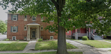 Kalamazoo apartment for rent - A red brick building with a tree in front.