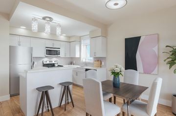 Kemptville apartment for rent - A modern kitchen with a dining table set for two.