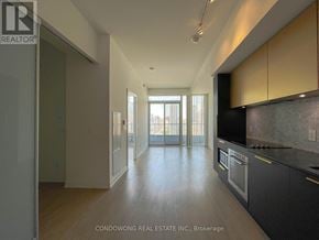 Toronto (Church-Yonge Corridor) condo for rent - A spacious kitchen with wooden floors and modern appliances.