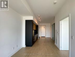 Toronto (Church-Yonge Corridor) condo for rent - A long hallway with a black cabinet on the left and a white door on the right.