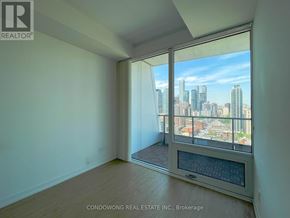 Toronto (Church-Yonge Corridor) condo for rent - A room with a large window overlooking a cityscape.