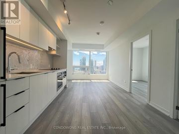 Toronto (Church-Yonge Corridor) condo for rent - A kitchen with white cabinets and a wooden floor.