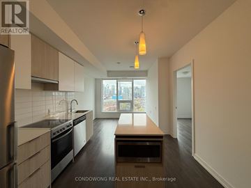 Toronto (Kensington-Chinatown) condo for rent - A modern kitchen with a stove top oven and a refrigerator.