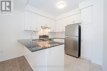 Brampton (Northwest Brampton) townhouse for rent - A kitchen with a granite counter top and stainless steel appliances.