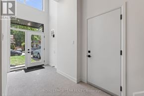 Ottawa duplex for rent - A white door with a black handle is in a room with white walls.
