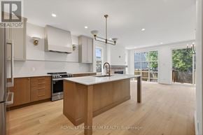 Ottawa duplex for rent - A modern kitchen with wooden floors and a central island.