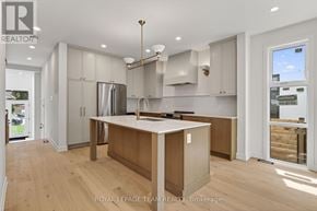 Ottawa duplex for rent - A modern kitchen with wooden floors and a central island.