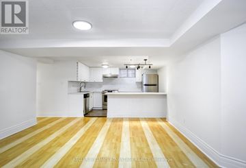 Toronto (Annex) apartment for rent - A kitchen with white cabinets and a wooden floor.
