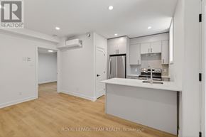 Ottawa apartment for rent - A kitchen area with a refrigerator, cabinets, and a countertop.