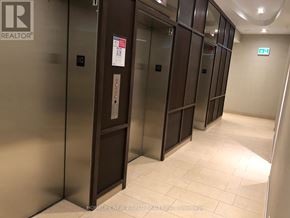 Toronto (Newtonbrook West) condo for rent - A hallway with elevators and a sign that says REALTOR.