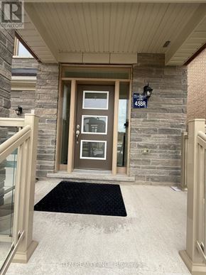 Hamilton (Waterdown) apartment for rent - The front door of a house with a glass panel and a sign above it.