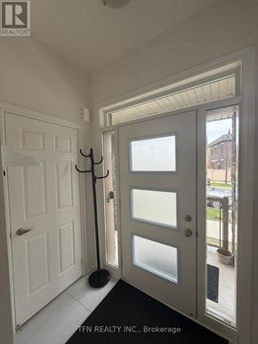 Hamilton (Waterdown) apartment for rent - A white door with frosted glass panels is open to a balcony.