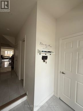 Hamilton (Waterdown) apartment for rent - A hallway with a sign that says "Be the change you wish to see in the world" on the wall.