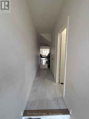 Hamilton (Waterdown) apartment for rent - A long hallway with a sign that says TFN REALTY INC. Brokerage.