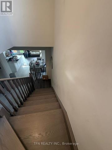 Hamilton (Waterdown) apartment for rent - A staircase leading to a living room with a dining table and chairs.