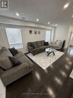 Whitchurch-Stouffville (Stouffville) townhouse for rent - A living room with a grey couch and a coffee table.