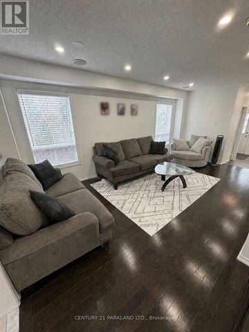 Whitchurch-Stouffville (Stouffville) townhouse for rent - A living room with a grey couch and a coffee table.