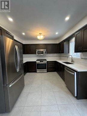 Whitchurch-Stouffville (Stouffville) townhouse for rent - A modern kitchen with a stainless steel refrigerator and black cabinets.