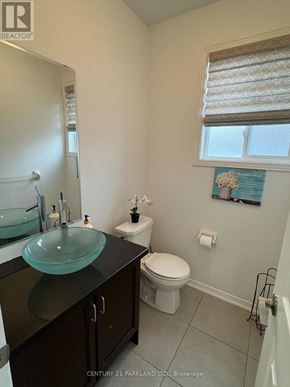 Whitchurch-Stouffville (Stouffville) townhouse for rent - A bathroom with a toilet, sink, and window.