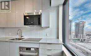 Vaughan (Concord) condo for rent - A modern kitchen with a view of a construction site outside the window.