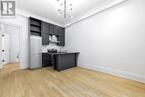 Toronto (Roncesvalles) apartment for rent - A kitchen with wooden floors and a refrigerator.
