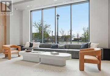 Burlington (Brant) condo for rent - A modern living room with a grey couch and a large window.