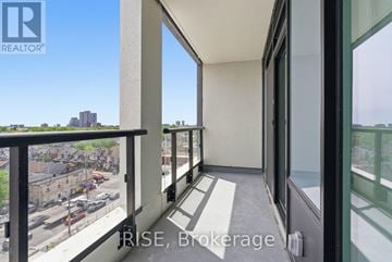 Toronto (Dovercourt-Wallace Emerson-Junction) condo for rent - A balcony with a view of a parking lot and buildings.