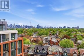 Toronto (Dovercourt-Wallace Emerson-Junction) condo for rent - A real estate company logo is displayed on a building in a cityscape.