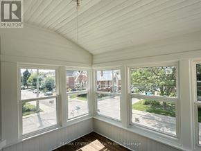 St. Thomas fourplex for rent - A room with white walls and a white ceiling with a window that has a view of a street.